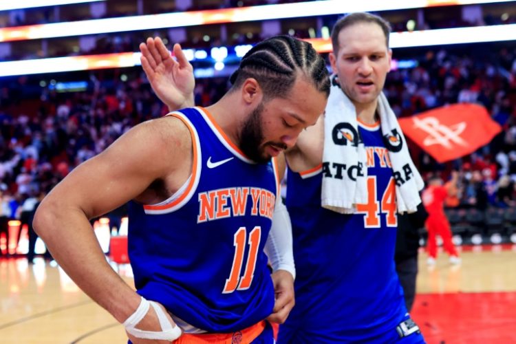 Jalen Brunson of the New York Knicks, front, hangs his head as he walks off the court following a foul that set up the decisive free throws in Houston's 105-103 victory, which was upheld by the NBA after a protest from the Knicks over the foul call on Brunson. ©AFP