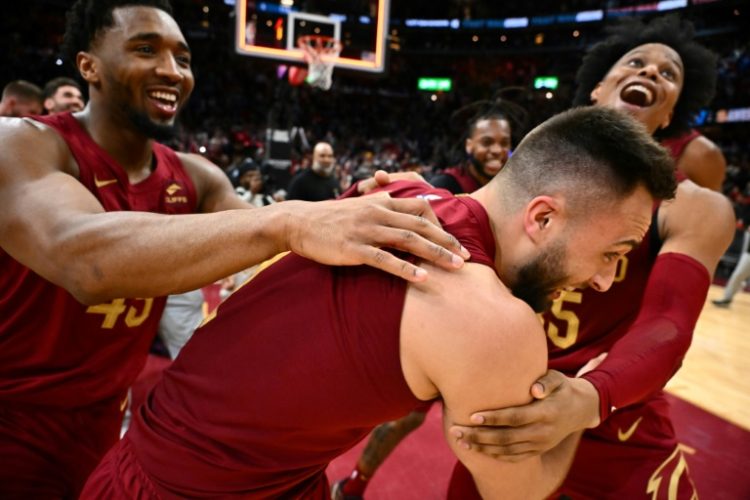 Cleveland's Max Strus is mobbed by team-mates after his monster buzzer-beater in the Cavaliers 121-119 win over Dallas. ©AFP
