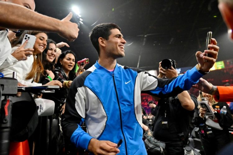 Spain's Carlos Alcaraz takes selfies with fans after winning an exhibition match against Rafael Nadal in Las Vegas. ©AFP