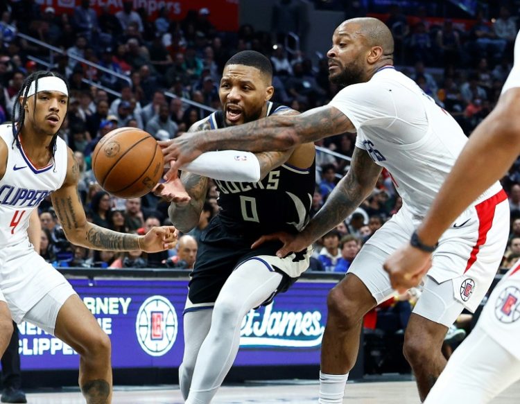 Milwaukee's Damian Lillard controls the ball against P.J. Tucker of the LA Clippers in the second half of the Bucks' NBA victory over the Clippers in Los Angeles. ©AFP