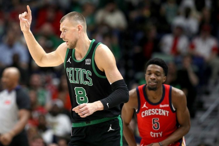 Boston's Kristaps Porzingis, front, celebrates his lone 3-point basket of the night while Herbert Jones watches in the Celtics' NBA triumph over New Orleans. ©AFP