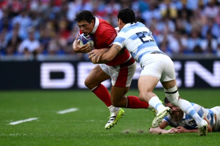 Wales winger Louis Rees-Zammit is tackled during the World Cup quater-final against Argentina.. ©AFP