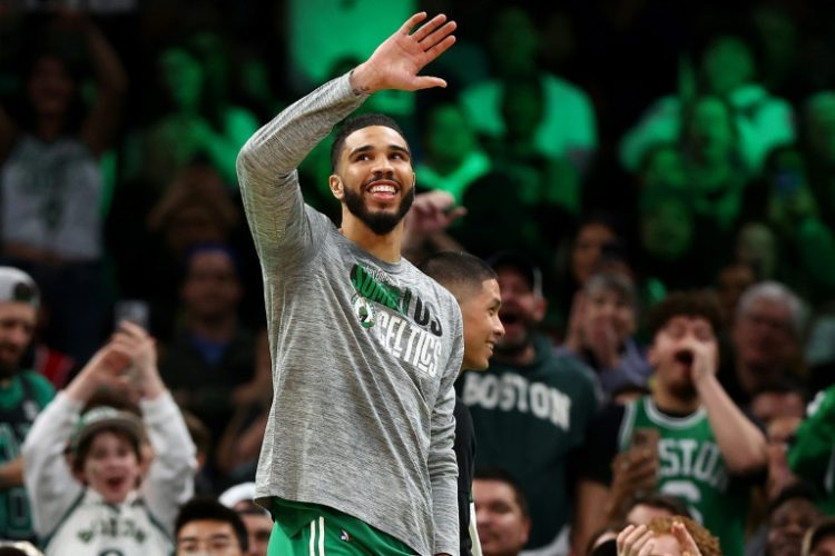 Jayson Tatum of the Boston Celtics waves to fans as they sing Happy Birthday on his 26th birthday in the second half of Boston's blowout NBA victory over Golden State. ©AFP