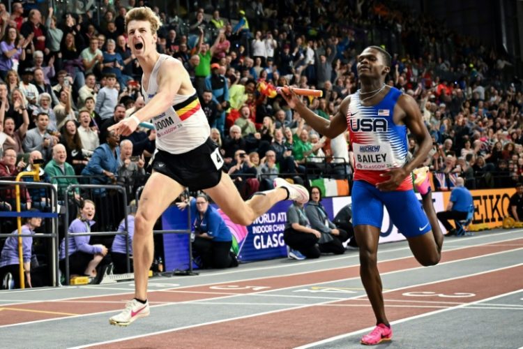 Belgium's Alexander Doom (L) crosses the finish line past USA's Chris Bailey to win the men's world indoor 4x400m relay. ©AFP
