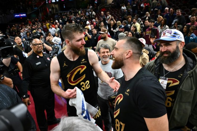 Cleveland Cavaliers player Dean Wade is congratulated by NFL stars Travis and Jason Kelce after leading a late comeback to beat Boston. ©AFP