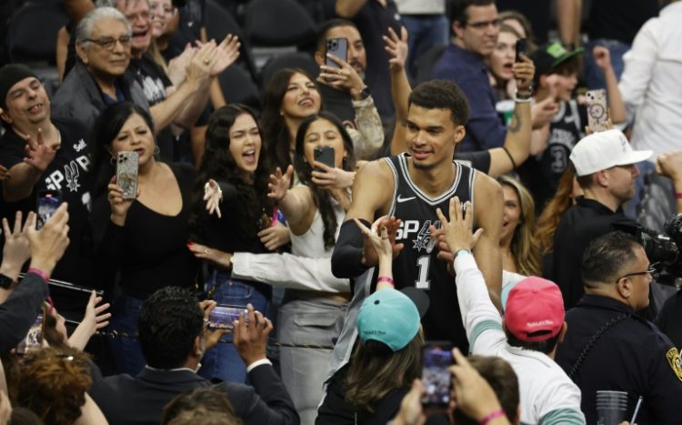 Sensational: San Antonio rookie Victor Wembanyama celebrates with fans after the Spurs' NBA overtime victory over the New York Knicks. ©AFP