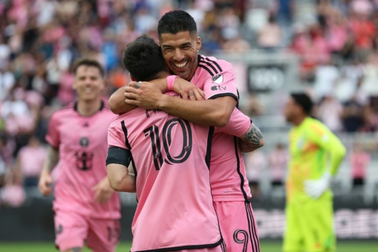 Luis Suarez celebrates with Lionel Messi after scoring in Inter Miami's 5-0 win over Orlando in MLS on Saturday.. ©AFP