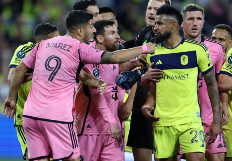 Luis Suarez and Lionel Messi of Inter Miami CF have words with Anibal Godoy of Nashville SC during the second half of the Concacaf Champions Cup match on Thursday.. ©AFP