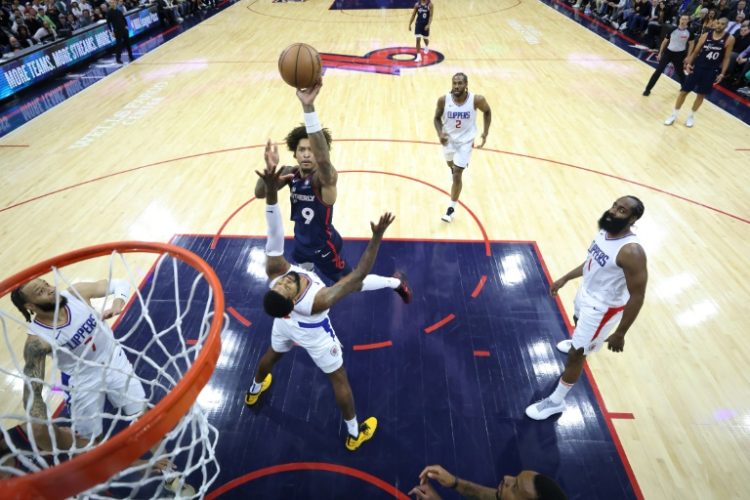Philadelphia's Kelly Oubre Jr., shooting over Paul George of the Los Angeles Clippers, was fined $50,000 as was Sixers coach Nick Nurse for complaining on a later play in the team's home loss to the Clippers. ©AFP