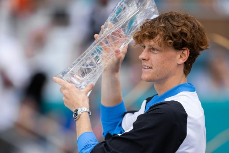 Jannik Sinner of Italy celebrates with the trophy after defeating Grigor Dimitrov of Bulgaria 6-3, 6-1 in the men's final of the Miami Open on Sunday.. ©AFP