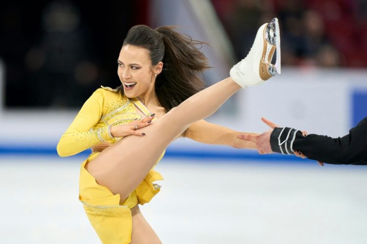 Madison Chock, shown holding onto the hand of partner Evan Bates, performs in the rhythm dance, which the US duo won to grab the lead at the World Figure Skating Championships in Montreal. ©AFP