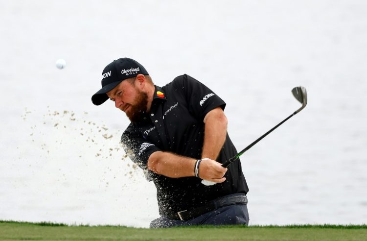 Ireland's Shane Lowry plays out of a bunker on the way to a birdie at 18 and a share of the 54-hole lead in the US PGA Tour Cognizant Classic. ©AFP