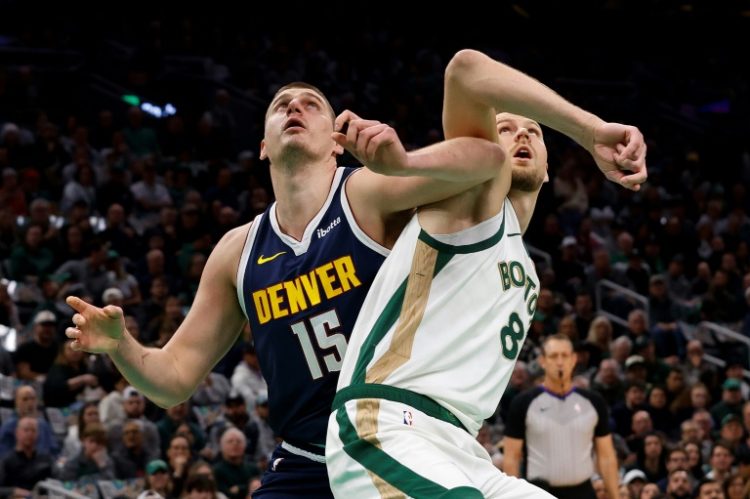 Denver's Nikola Jokic, left, battled for position under the basket with Boston's Kristaps Porzingis in a matchup of clubs that will meet again in two pre-season contests next October at Abu Dhabi, the NBA announced. ©AFP