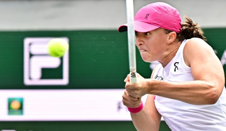 World number one Iga Swiatek hits a backhand on the way to victory over Greece's Maria Sakkari in the women's final of the ATP-WTA Indian Wells Masters. ©AFP