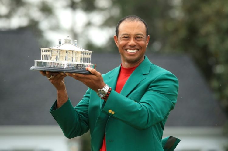 Tiger Woods, shown celebrating his 2019 Masters triumph, was listed in the field of players for next month's major championship at Augusta National on the tournament website. ©AFP