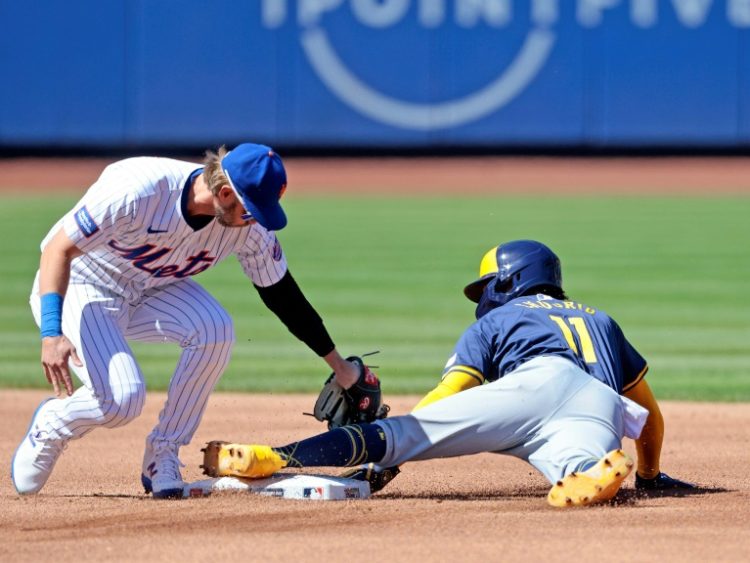 Milwaukee's Jackson Chourio, the youngest MLB opener leadoff hitter since 1937 at age 20, steals second base under the tag attempt of Jeff McNeil of the New York Mets in the Brewers' 3-1 victory. ©AFP