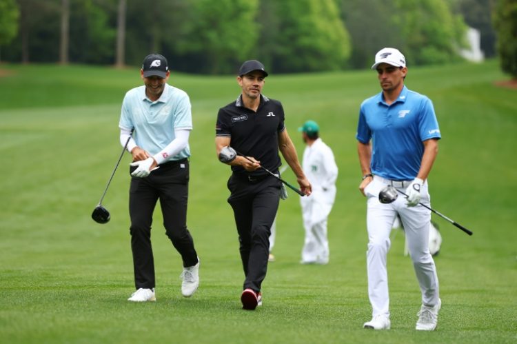 LIV Golf's Sergio Garcia of Spain, left, and Joaquin Niemann of Chile, right, walk alongside PGA player Camilo Villegas of Colombia, center, during a practice round for the 88th Masters. ©AFP