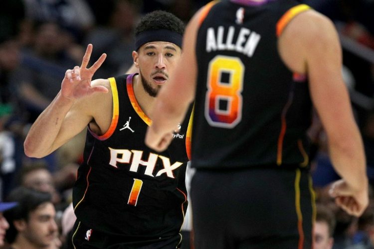 Devin Booker reacts to a three-pointer on his way to a 52-point display in Phoenix's win over New Orleans. ©AFP