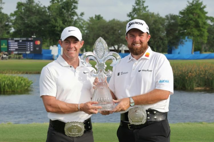 Rory McIlroy and Shane Lowry pose with the trophy after winning the Zurich Classic of New Orleans at TPC Louisiana on Sunday.. ©AFP