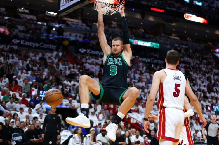 Latvian Kristaps Porzingis of the Boston Celtics, dunking in a game-three NBA playoff victory over Miami, will miss game five of the first-round series after suffering a strained calf in Boston's game-four victory. ©AFP