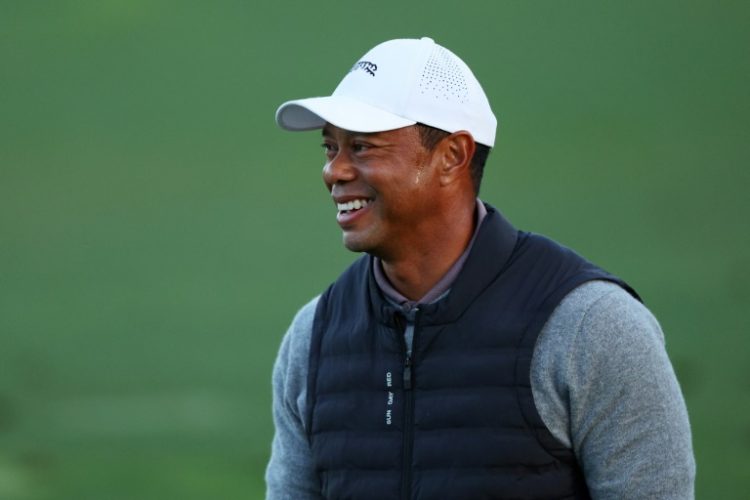 Tiger Woods, a 15-time major winner and five-time Masters champion, laughs during his warm-up work at Augusta National before the resumption of the opening round of the 88th Masters. ©AFP