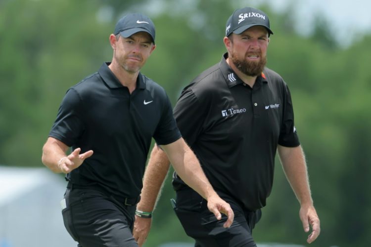 Rory McIlroy of Northern Ireland and Shane Lowry of Ireland wave to fans during the second round of the Zurich Classic of New Orleans at TPC Louisiana.. ©AFP