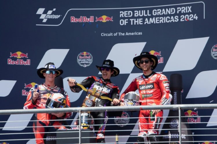 Maverick Vinales of Spain celebrates victory in the MotoGP of the Americas flanked by runner-up Pedro Acosta and third-placed Enea Bastianini . ©AFP