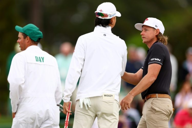 Min Woo Lee (left) and Cameron Smith of Australia chat during their practice round Tuesday prior to the 2024 Masters. ©AFP