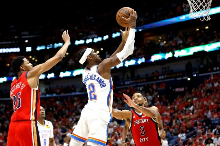 Shai Gilgeous-Alexander of the Oklahoma City Thunder shoots over CJ McCollum in the Thunder's victory over the New Orleans Pelicans in game three of their NBA Western Conference first round playoff series. ©AFP
