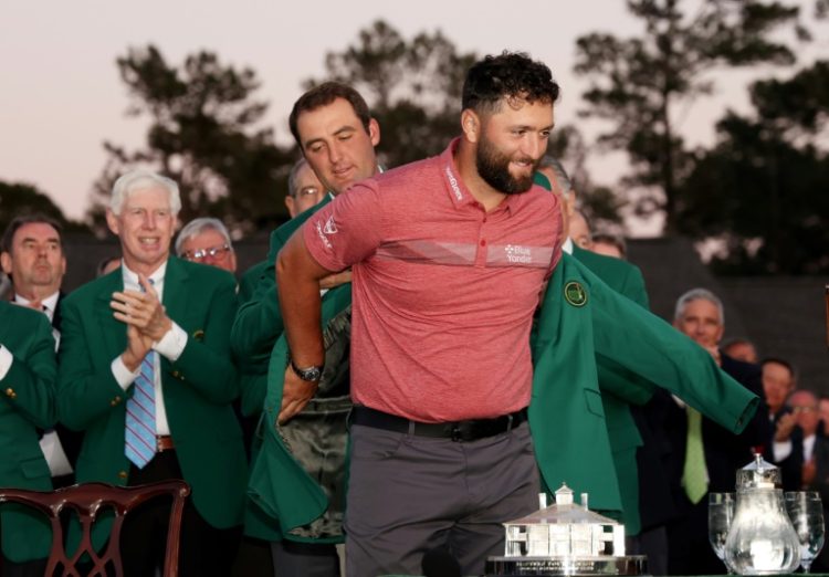 Spain's Jon Rahm is helped into the Masters winner's green jacket by 2022 Masters winner Scottie Scheffler and both men are among those fancied to lift the trophy in next week's showdown at Augusta National. ©AFP