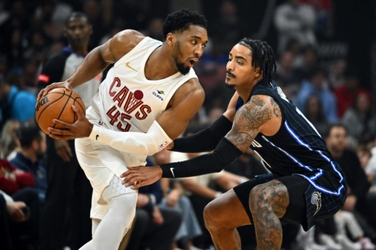 Donovan Mitchell of the Cleveland Cavaliers looks for a pass while under pressure from Gary Harris in the Cavaliers' victory over the Orlando Magic in game one of their NBA Eastern Conference first round playoff series. ©AFP