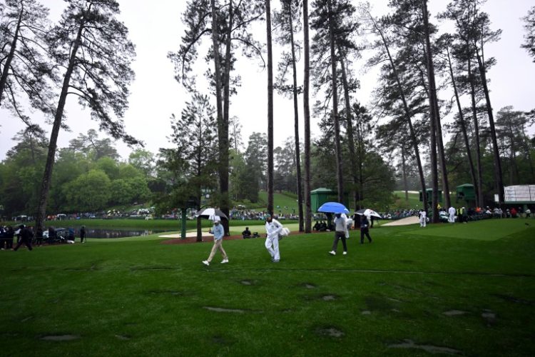 Players walk by the location where trees fell due to weather on the 17th hole last year during the second round of the Masters. ©AFP
