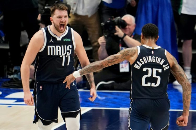 Luka Doncic and P.J. Washington of the Dallas Mavericks celebrate during the final minute of the Mavs' win over Minnesota in game three of the NBA Western Conference finals. ©AFP