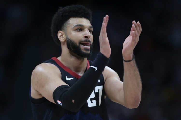 Denver Nuggets guard Jamal Murray, celebrating a foul called against Minnesota, was fined $100,000 by the NBA for throwing multiple objects, including a heating pad, at a referee during play in an NBA playoff contest. ©AFP