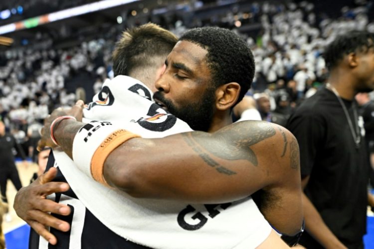 Dallas Mavericks' Kyrie Irving hugs teammate Luka Doncic after defeating the Minnesota Timberwolves 108-105. ©AFP