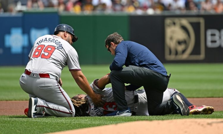 Ronald Acuna of the Atlanta Braves is attended to after suffering a season-ending torn knee ligament in an MLB game against Pittsburgh. ©AFP