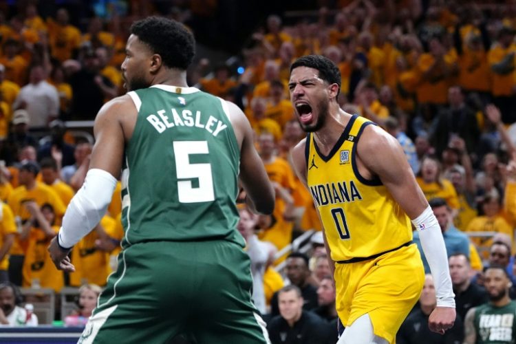 Tyrese Haliburton of the Indiana Pacers reacts after a dunk while Milwaukee's Malik Beasley looks on during the Pacers' series-clinching victory over the Bucks in game six of their NBA Eastern Conference first round playoff series. ©AFP