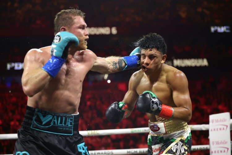 Saul 'Canelo' Alvarez lands a left against Jaime Munguia on the way to a unanimous decision victory in their super-middleweight world title fight in Las Vegas. ©AFP
