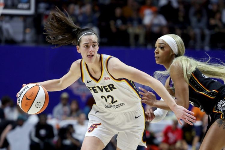 Caitlin Clark of the Indiana Fever dribbles against DiJonai Carrington of the Connecticut Sun in the rookie's WNBA debut on Tuesday.. ©AFP