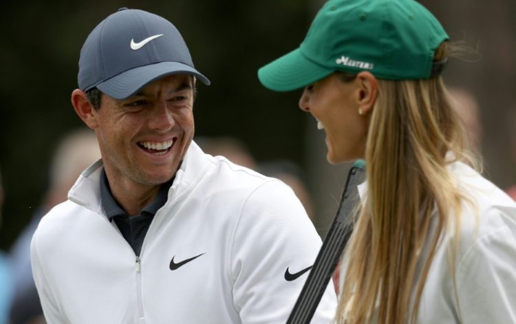 Second-ranked Rory McIlroy of Northern Ireland, left, has reportedly filed for divorce from his wife Erica, right, who is shown with McIlroy at the 2018 Masters Par-3 Contest. ©AFP