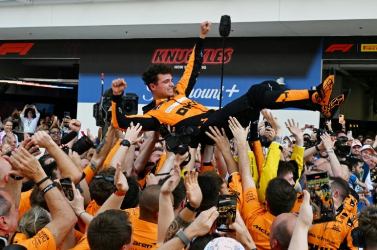 McLaren's Lando Norris is tossed in the air as his team celebrates victory at the Miami Grand Prix on Sunday. ©AFP