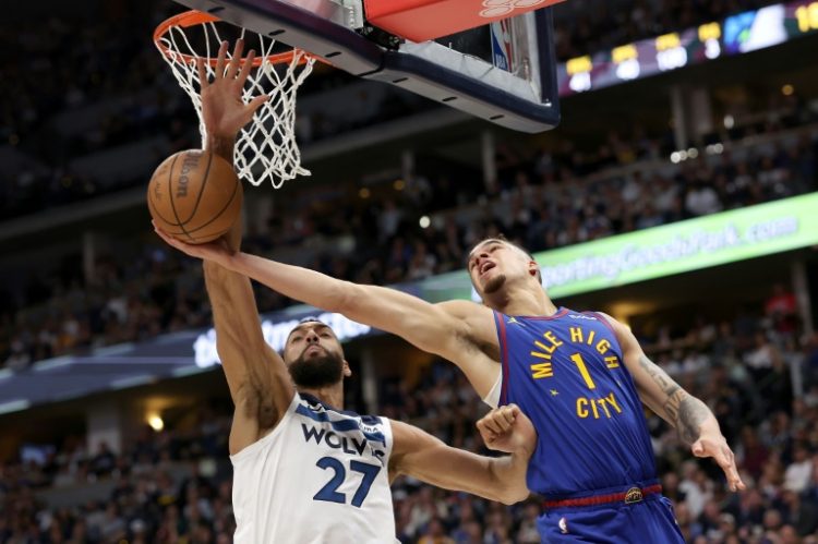 Minnesota's Rudy Gobert (left) blocks Denver's Michael Porter Jr; Gobert has been named NBA's Defensive Player of the Year for the fourth time. ©AFP