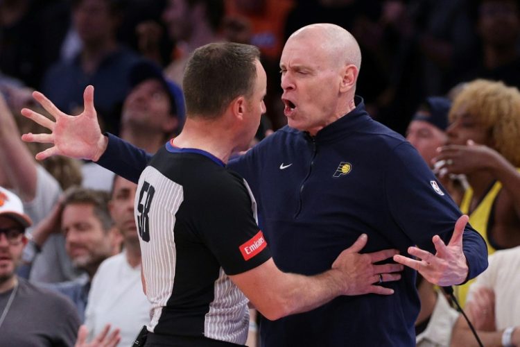 Indiana Pacers head coach Rick Carlisle, at right arguing a call with referee Josh Tiven, was fined $35,000 by the NBA on Friday for criticizing the officiating and questioning the integrity of the league. ©AFP
