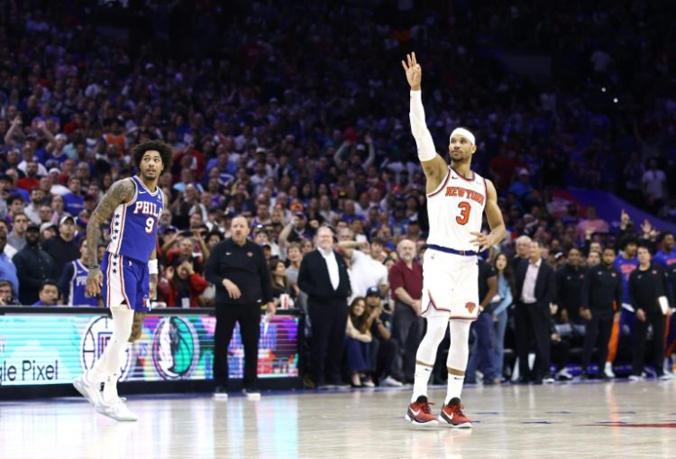 New York's Josh Hart celebrates his late three-pointer as Philadelphia's Kelly Oubre looks on in the Knicks' series-clinching victory over the 76ers in game six of their NBA Eastern Conference first round playoff series. ©AFP