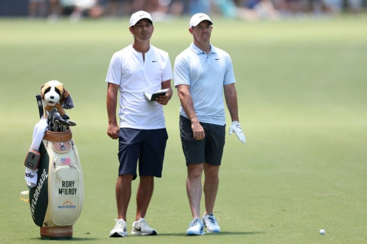 Four-time major winner Rory McIlroy, right, and his caddie Harry Diamond prepare for a shot Tuesday during a practice round ahead of the US Open at Pinehurst. ©AFP