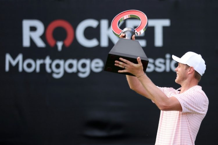 Cameron Davis of Australia celebrates with the trophy after winning his second PGA Rocket Mortgage Classic. ©AFP