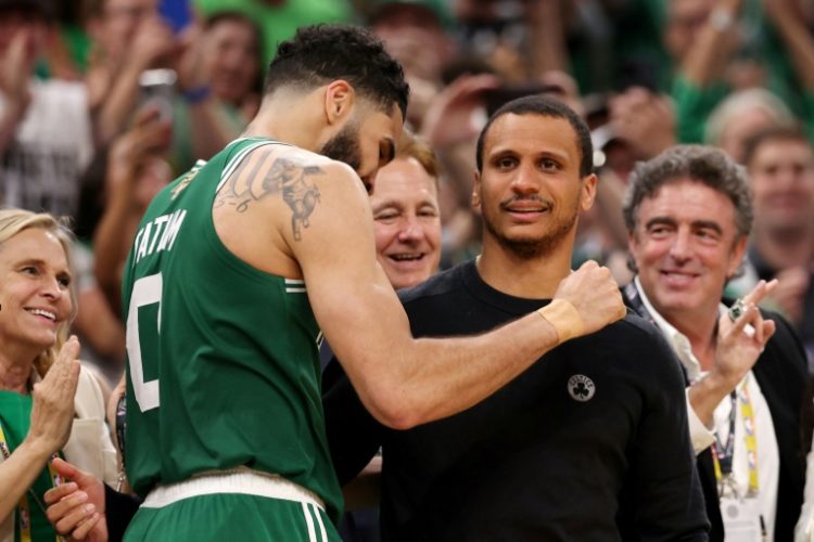 Jayson Tatum (left) hugs Boston Celtics head coach Joe Mazzulla during their series clinching win over Dallas in the NBA Finals on Monday. ©AFP