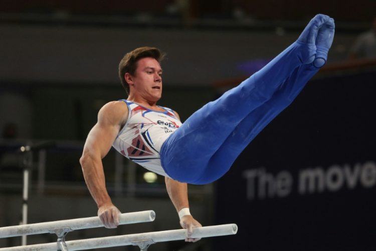 Brody Malone competes on the parallel bars on the way to the men's all-around title at the US Gymnastics Championships. ©AFP