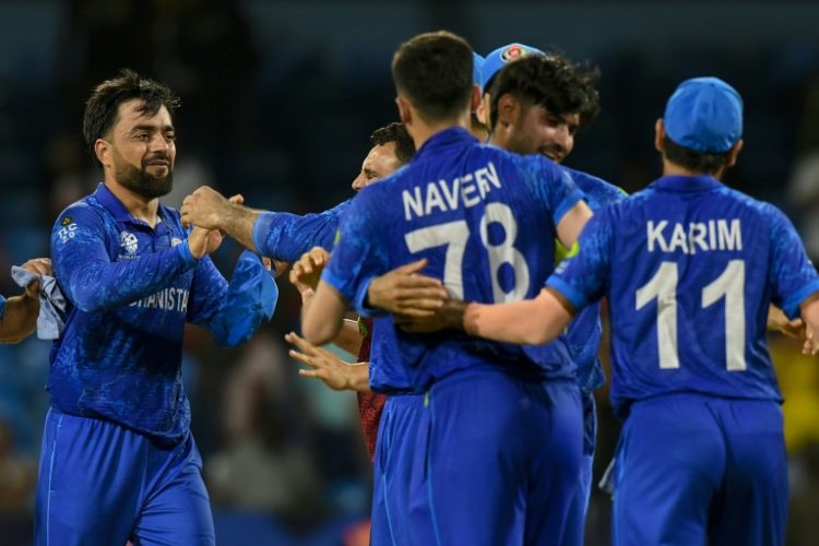Afghanistan captain Rashid Khan (L) celebrates with his teammates after the 'massive' win over Australia at the T20 World Cup. ©AFP