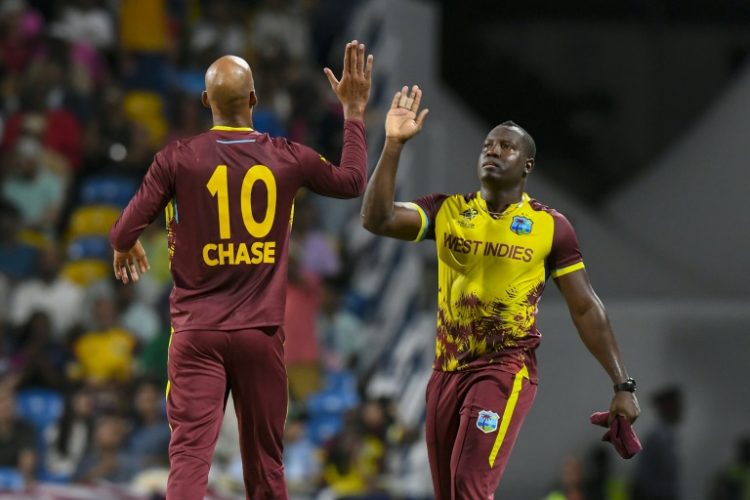 West Indies' Roston Chase (left) celebrates a wicket in Friday's T20 Super Eight clash with the United States. ©AFP